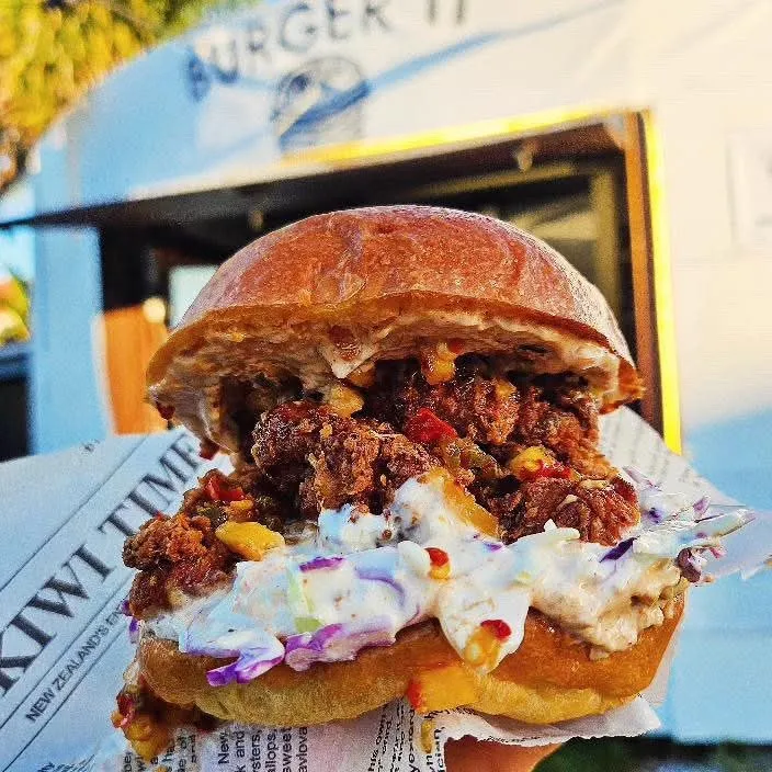 Burger It fried chicken burger in front of the food truck