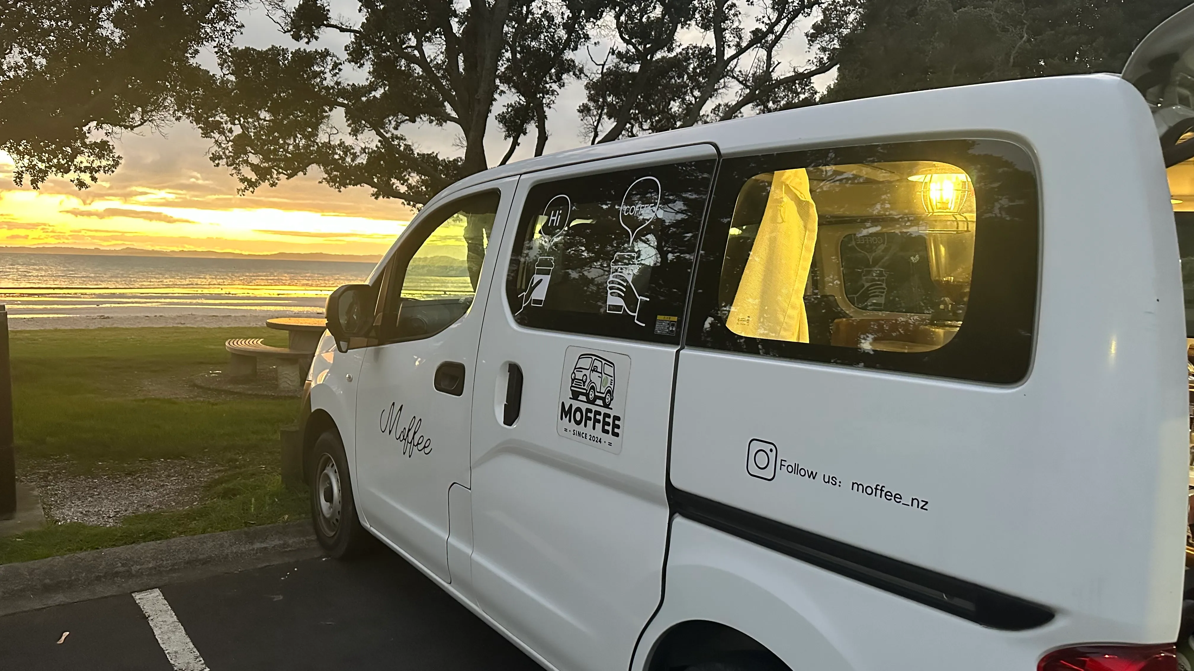 Moffee mobile coffee van parked by the waterfront at sunset