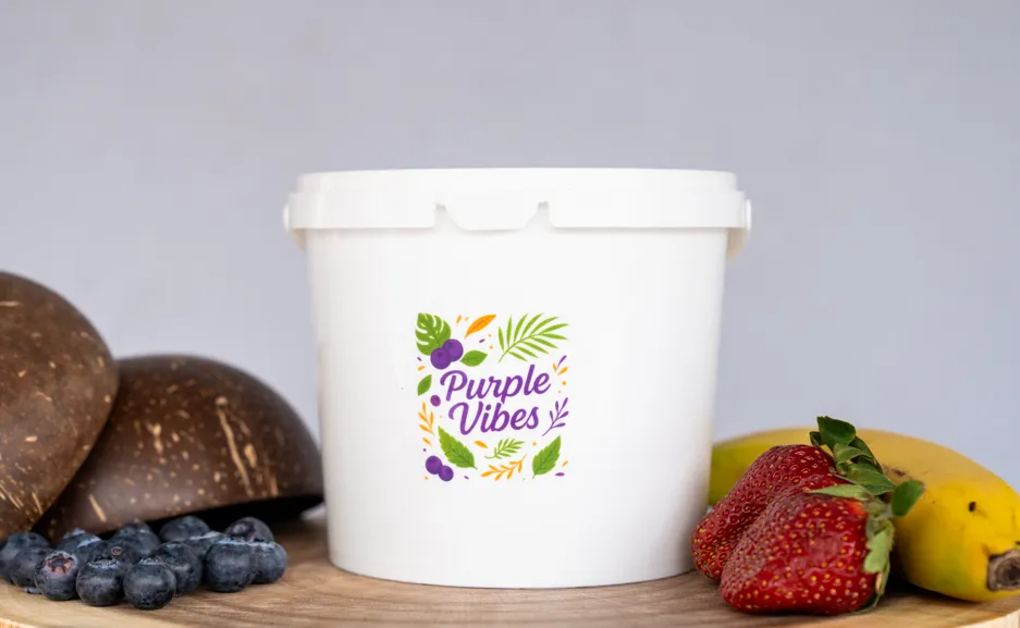 A Purple Vibes branded tub surrounded by fresh strawberries, banana, blueberries and coconut